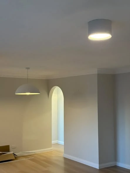 Pendant and surface-mounted downlights installed in a renovated Brisbane room